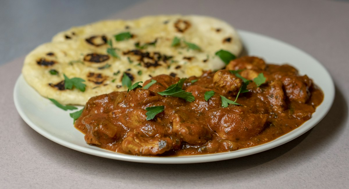 Warm café table with freshly prepared South Asian flatbreads and hot tea